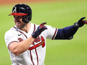 Adam Duvall of the Atlanta Braves celebrates after hitting a grand slam during the seventh inning of a game against the Miami Marlins at Truist Park on Sept. 9, 2020 in Atlanta, Ga.