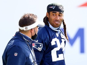 Stephon Gilmore of the New England Patriots arrives to Patriots Training camp with Offensive Coordinator Josh MlcDaniels at Gillette Stadium on August 26, 2020 in Foxborough, Massachusetts.