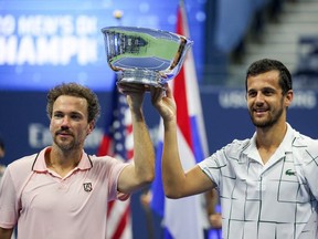 Mate Pavic (R) of Croatia and Bruno Soares (L) of Brazil celebrate with the trophy after winning their Men's Doubles final match against Wesley Koolhof of the Netherlands and Nikola Mektic of Croatia on Day Eleven of the 2020 US Open at the USTA Billie Jean King National Tennis Center on September 10, 2020 in the Queens borough of New York City.