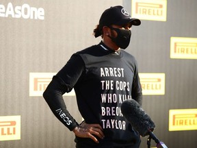 Race winner Lewis Hamilton of Great Britain and Mercedes GP wears a shirt in tribute to the late Breonna Taylor as he talks to the media in parc ferme during the F1 Grand Prix of Tuscany at Mugello Circuit on September 13, 2020 in Scarperia, Italy.