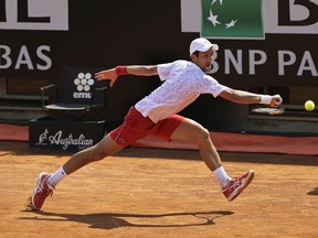 Novak Djokovic of Serbia stretches to play a backhand in his round two match against Salvatore Caruso of Italy during day three of the Internazionali BNL d'Italia at Foro Italico on September 16, 2020 in Rome, Italy.