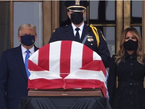 U.S. President Donald Trump and first lady Melania Trump pay their respects to Associate Justice Ruth Bader Ginsburg's flag-draped casket on the Lincoln catafalque on the west front of the U.S. Supreme Court September 24, 2020 in Washington, DC.