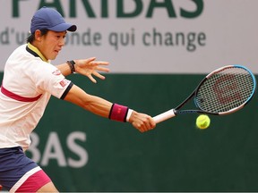 Kei Nishikori of Japan plays a backhand during his Men's Singles first round match against Daniel Evans of Great Britain during day one of the 2020 French Open at Roland Garros on September 27, 2020 in Paris, France.