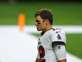 Tampa Bay Buccaneers quarterback Tom Brady walks off the field after a 34-23 loss against the New Orleans Saints on Sunday.
