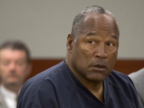 O.J. Simpson listens as his defense attorney, Ozzie Fumo, questions witness David Cook during an evidentiary hearing in Clark County District Court May 16, 2013 in Las Vegas, Nevada.