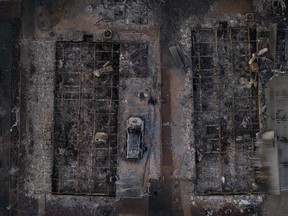 The skeleton of a vehicle lies between residences in the Bear Lakes Estates neighborhood which were left devastated by the Almeda fire in Phoenix, Oregon, Sept. 9, 2020. Picture taken with a drone.