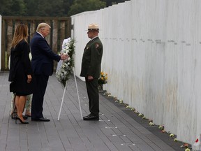 U.S. President Donald Trump and first lady Melania Trump place a wreath during a ceremony at the Flight 93 National Memorial, remembering those killed when hijacked Flight 93 crashed into an open field on Sept. 11, 2001, in Stoystown, Pa., Sept. 11, 2020.