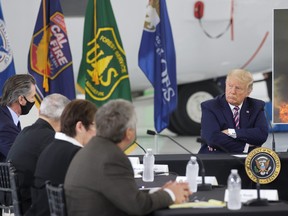 U.S. President Donald Trump listens  as California Governor Gavin Newsom speaks during a briefing on wildfires in McClellan Park, Calif., Sept. 14, 2020.