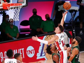 Miami Heat guard Tyler Herro, second from right, commits an offensive foul against Boston Celtics guard Jaylen Brown, right, during the fourth quarter in game two of the Eastern Conference Finals of the 2020 NBA Playoffs at ESPN Wide World of Sports Complex, Sept. 17, 2020.