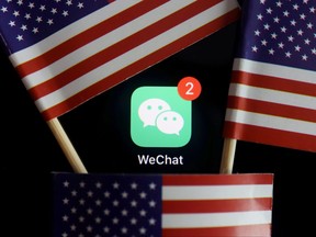 The messenger app WeChat is seen among U.S. flags in this illustration picture taken Aug. 7, 2020.