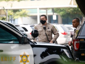 Los Angeles County Sheriff’s Department deputies stand outside St. Francis Medical Center following the ambush shooting of two deputies in Compton, in Lynwood, California September 13, 2020.