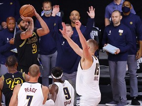 Lakers' Anthony Davis shoots a three point basket to win the game over the Nuggets in Game 2 of the Western Conference Finals during the 2020 NBA Playoffs at AdventHealth Arena at the ESPN Wide World Of Sports Complex in Lake Buena Vista, Fla., Sunday, Sept. 20, 2020.