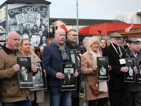 Relatives and supporters of the victims of the 1972 Bloody Sunday killings hold images of those who died as they march from the Bogside area of Derry, Northern Ireland on March 14, 2019.