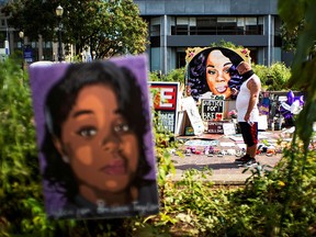 A man pauses at the memorial of Breonna Taylor before a march in Louisville, Kentucky  September 25, 2020.
