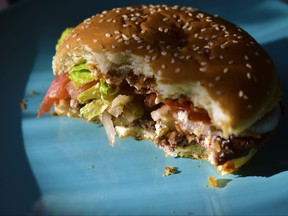 A half-eaten meat burger with vegetables is pictured in this file photo.