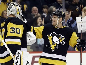 Pittsburgh Penguins goaltender Matt Murray (30) and right wing Patric Hornqvist (72) celebrate after defeating the Ottawa Senators at PPG PAINTS Arena.