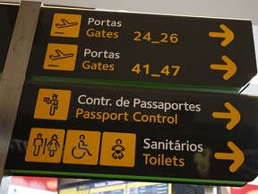 Gates, passport control and toilets signs are seen at Lisbon airport, Portugal, June 24, 2016.