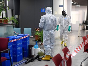 Members of the Spanish Military Emergencies Unit (UME) wearing protective gear prepare to disinfect the Lope de Vega Cultural Center in the Vallecas neighbourhood where rapid antigen test for COVID-19 were conducted to residents of the area, on September 30, 2020 in Madrid.
