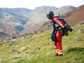 A handout picture released on September 25, 2020 by the Great North Air Ambulance Service (GNAAS) shows Gravity Industries founder and pilot Richard Browning taking part in a test flight of his jet-powered suit at Langdale pikes in the Lake District.