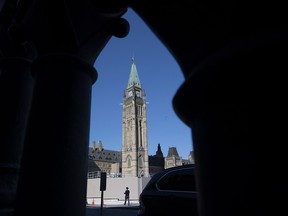 A man walks outside Parliament buildings in Ottawa, Monday September 21, 2020.