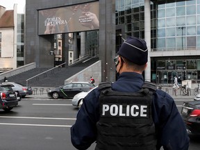 A French police officer stands near the Opera Bastille where a suspect in a stabbing attack near the former offices of the magazine Charlie Hebdo was arrested in Paris September 25, 2020.