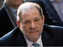 In this file photo taken on February 24, 2020 Harvey Weinstein arrives at the Manhattan Criminal Court in New York City.  