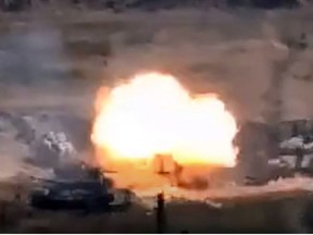 An image grab taken from a video made available on the official web site of the Armenian Defence Ministry on September 27, 2020, allegedly shows destroying of Azeri military vehicles during clashes between Armenian separatists and Azerbaijan in the breakaway region of Nagorno-Karabakh.