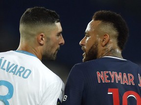 Paris St. Germain's Neymar, right, clashes with Olympique de Marseille's Alvaro Gonzalez during a Ligue 1 match at Parc des Princes, in Paris, Sunday, Sept. 13, 2020.