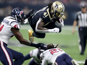 New Orleans Saints running back Alvin Kamara (41) dives over Houston Texans cornerback Bradley Roby (21) at the Mercedes-Benz Superdome.