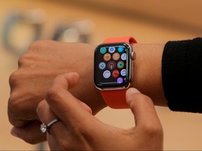 An Apple Store employee shows the new Series 5 Apple Watch during the preview of the redesigned and reimagined Apple Fifth Avenue store in New York, U.S., September 19, 2019.