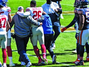 New York Giants running back Saquon Barkley is helped off the field with what appears to be aseason-ending knee injury suffered Sunday in Chicago.