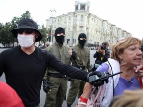 A law enforcement officer directs women during a rally against police brutality following protests to reject the presidential election results in Minsk, Belarus September 5, 2020.