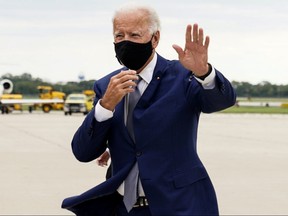 Democratic presidential nominee Joe Biden waves as he arrives at Milwaukee Mitchell International Airport in Milwaukee September 3, 2020.