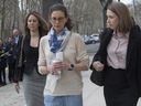 Clare Bronfman, centre, leaves Federal court in the Brooklyn borough of New York, Friday, April 19, 2019.