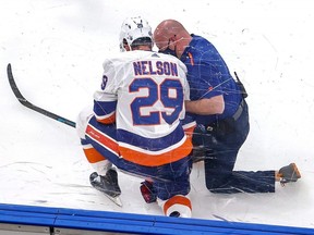 Brock Nelson of the New York Islanders is tended to by a trainer after sustaining an injury on a boarding penalty by Alex Killorn of the Tampa Bay Lightning at Rogers Place on September 9, 2020 in Edmonton.