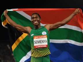 In this file photo taken April 13, 2018, South Africa's Caster Semenya celebrates with South Africa's flag after winning the women's 800m final during the 2018 Gold Coast Commonwealth Games at the Carrara Stadium on the Gold Coast, Australia.