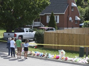 A steady stream of mourners arrive at the Oshawa home where a father and his three children were slain on Sunday Sept. 6, 2020.