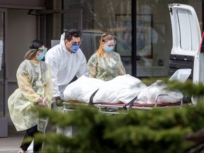 A body is removed after several residents died of the coronavirus disease at the Eatonville Care Centre in Toronto April 14, 2020.