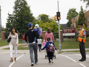 Students are dropped off at school ahead of their first day of classes in Pickering, Ont., Tuesday, Sept. 8, 2020.