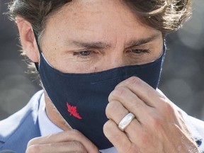 Prime Minister Justin Trudeau adjusts his mask following a news conference in Montreal, Monday, Aug 31, 2020.