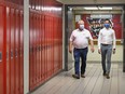Ontario Premier Doug Ford, left, and Education Minister Stephen Lecce walk the hallway before making an announcement regarding the governments plan for a safe reopening of schools in the fall due to the COVID-19 pandemic at Father Leo J Austin Catholic Secondary School in Whitby, Ont., on Thursday, July 30, 2020.