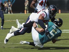 Blake Bortles of the Jacksonville Jaguars is brought down by Christian Covington of the Houston Texans at TIAA Bank Field on October 21, 2018 in Jacksonville.