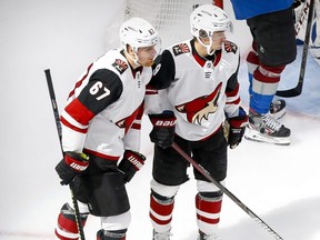 Coyotes left wing Lawson Crouse (left) and right wing Clayton Keller (right) celebrate a goal scored by Keller against the Avalanche during the third period in Game 5 of the first round of the 2020 Stanley Cup Playoffs at Rogers Place in Edmonton, Aug. 19, 2020.