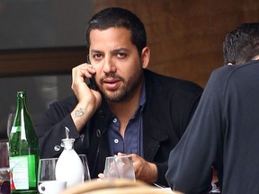 Magician David Blaine talks on the phone while having lunch with a friend at a Greenwich restaurant in 2010.