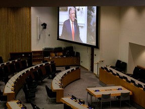 U.S. President Donald Trump is seen on a screen through a window to an empty conference room as he delivers a pre-recorded address to the 75th annual U.N. General Assembly at United Nations headquarters, which is being held mostly virtually due to COVID-19, in New York City, Sept. 22, 2020.