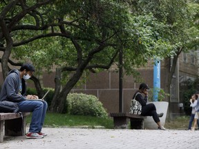 People sit outside at the Ryerson University campus in Toronto, Tuesday, Sept. 8, 2020.