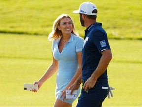 Dustin Johnson celebrates with his partner Paulina Gretzky on the 18th green after winning the FedExCup at East Lake Golf Club on September 7, 2020 in Atlanta.