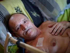 Alain Cocq, 57, in his medical bed he has been confined to for years as a result of a degenerative disease that has no treatment, poses after an interview with Reuters at his home in Dijon, France, August 19, 2020.