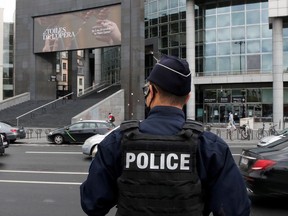 A French police officer stands near the Opera Bastille where a suspect in a stabbing attack near the former offices of the magazine Charlie Hebdo was arrested in Paris, France September 25, 2020.