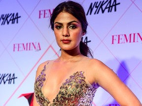 In this picture taken on Feb. 18, 2020, Bollywood actress Rhea Chakraborty poses for photographs as she arrives at the 'Nykaa Femina Beauty Awards 2020' in Mumbai.